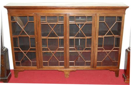 Appraisal: A Georgian style mahogany bookcase the projected moulded cornice over