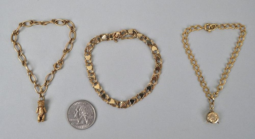 Appraisal: Two K Gold Charm Bracelets one gold filled with a