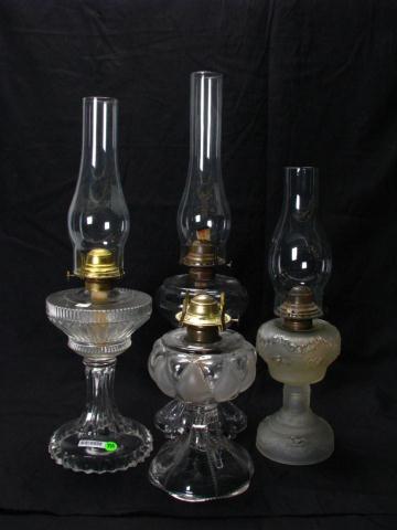 Appraisal: Four Oil Lamps including three with hurricanes '' and ''