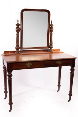 Appraisal: A Victorian mahogany dressing table with swing mirror on turned