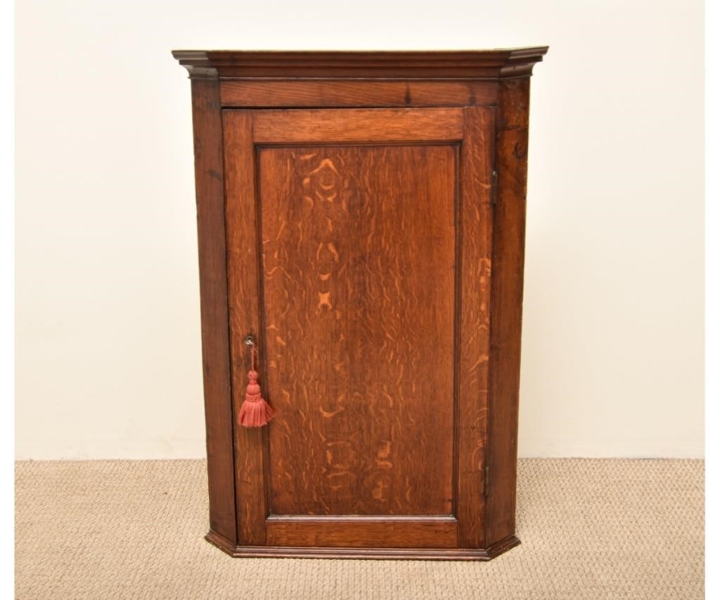 Appraisal: English oak corner cupboard th c with scalloped shelves h