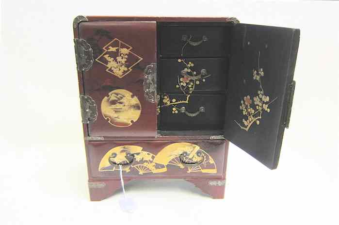 Appraisal: JAPANESE LACQUERED SMALL JEWELRY CABINET with gold decorated front whose