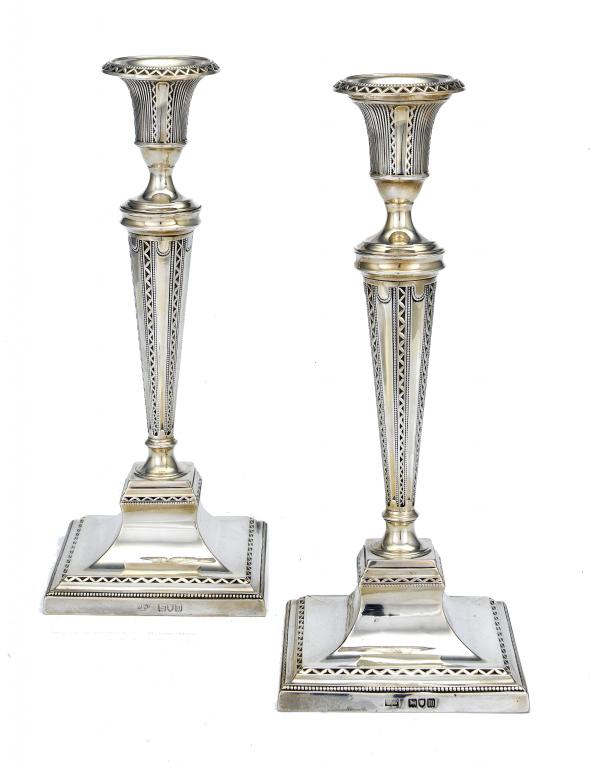 Appraisal: A PAIR OF EDWARD VII CANDLESTICKS in neo classical style