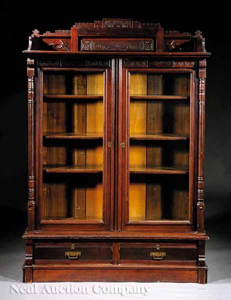 Appraisal: A Modern Gothic Carved Mahogany Bookcase c pedimented incised galleried