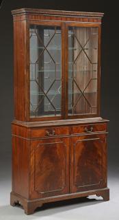 Appraisal: Georgian Style Carved Mahogany Bookcase Cupboard th c the dentillated