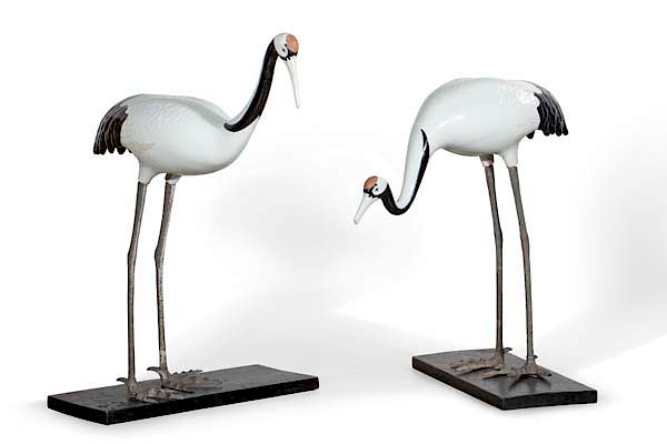 Appraisal: A pair of porcelain and metal standing cranes A pair