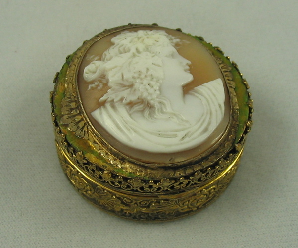 Appraisal: GILT METAL AND CARVED CAMEO COMPACT round form with filigree