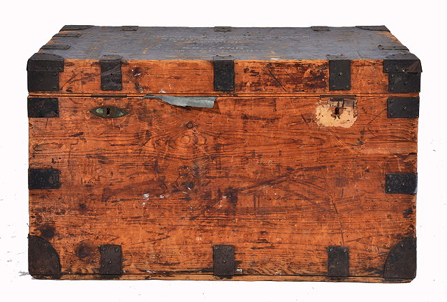 Appraisal: A PINE AND IRON BOUND TRAVELLING TRUNK with iron handles