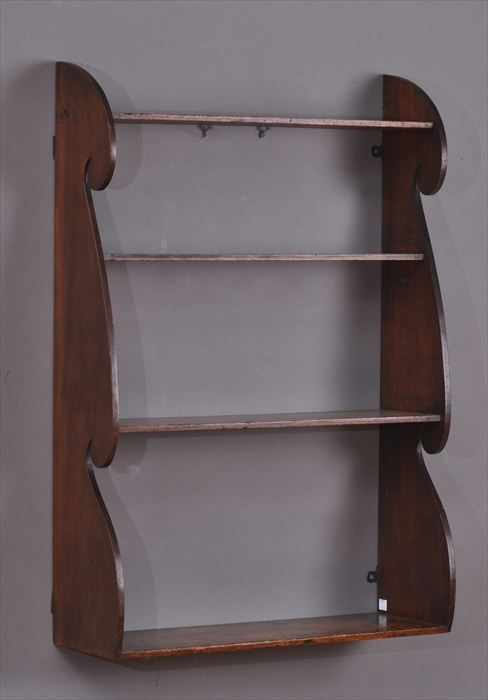 Appraisal: AMERICAN MAHOGANY HANGING SHELF Incorporating four shelves on shaped ends