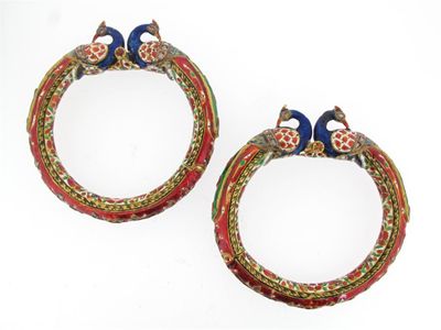 Appraisal: A pair of Indian gold hinged bangles with peacock terminals