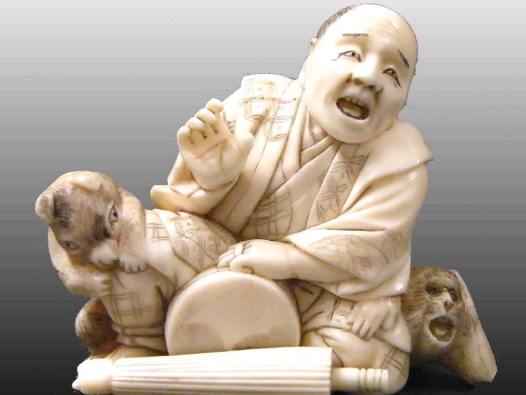 Appraisal: Japanese ivory netsuke of a street vendor accompanied by a