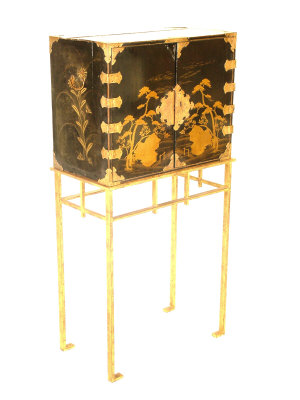 Appraisal: A Japanese black lacquered cabinet upon a gilt metal stand