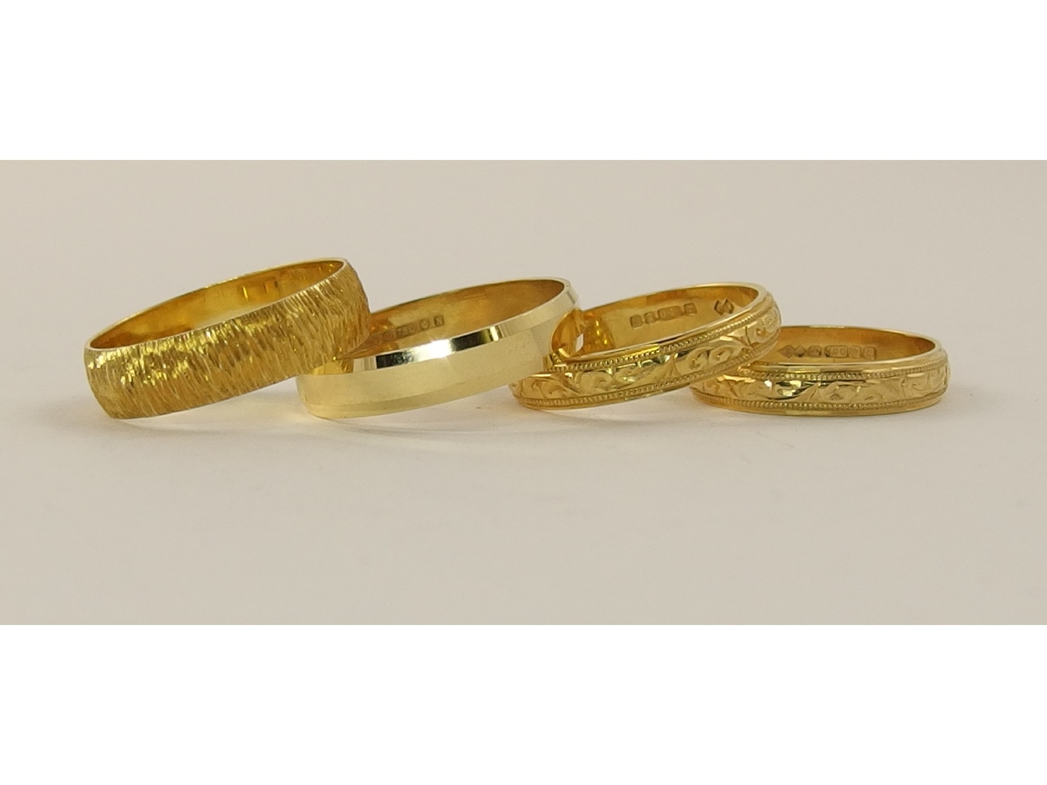 Appraisal: Four ct wedding bands two with engraved patterns a bark