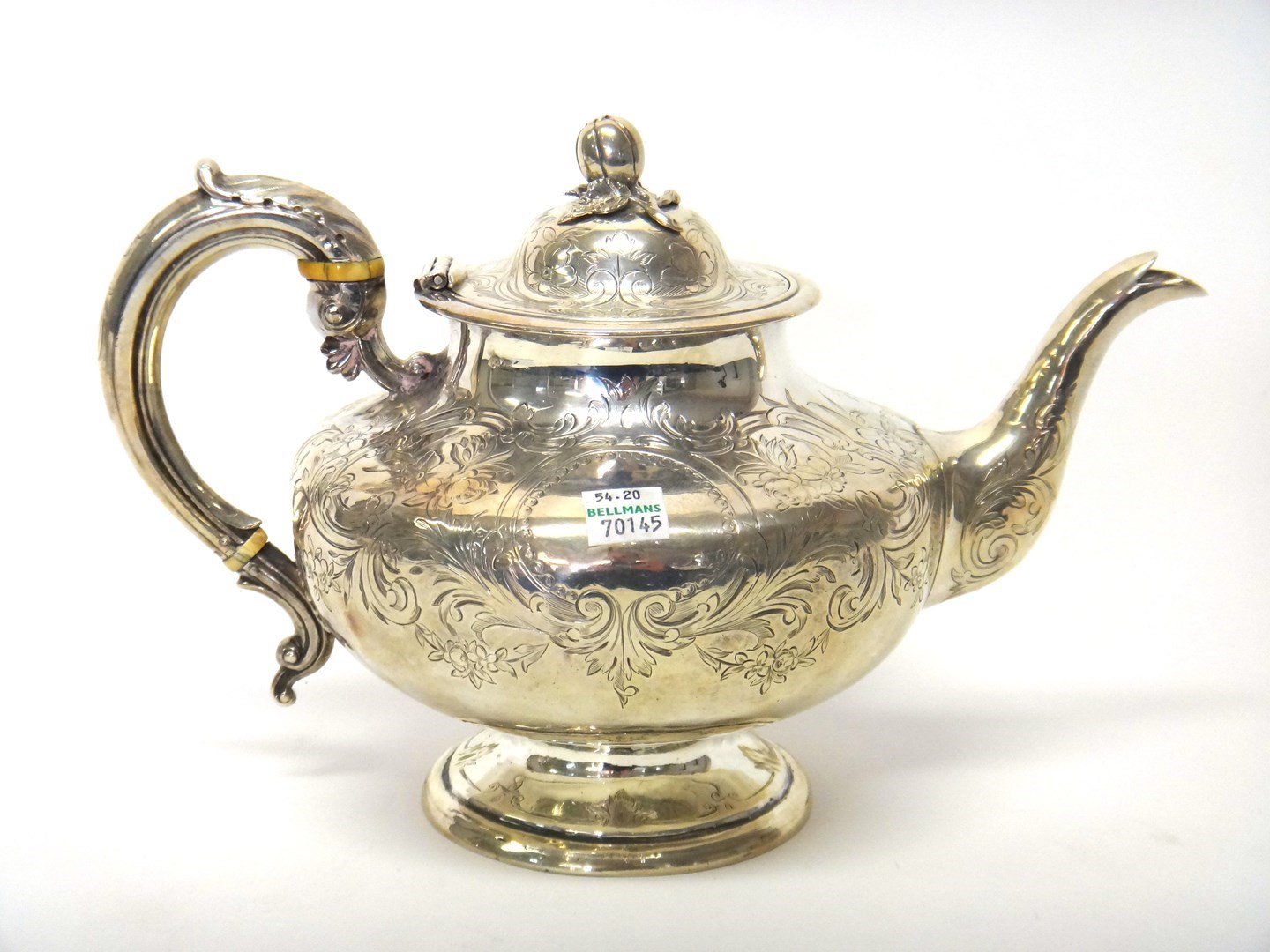 Appraisal: A Victorian silver teapot of compressed circular form the body