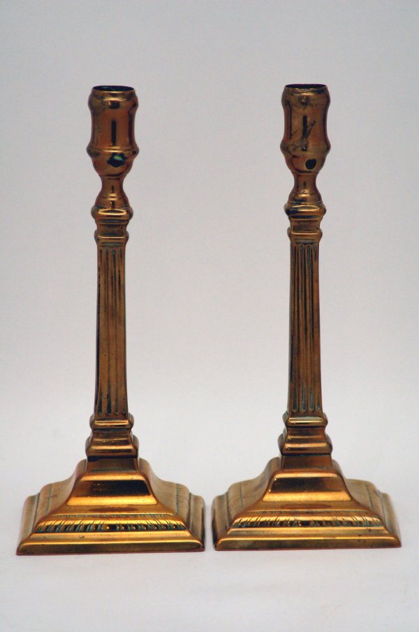 Appraisal: Pair of brass candlesticks with fluted columns square bases cupped