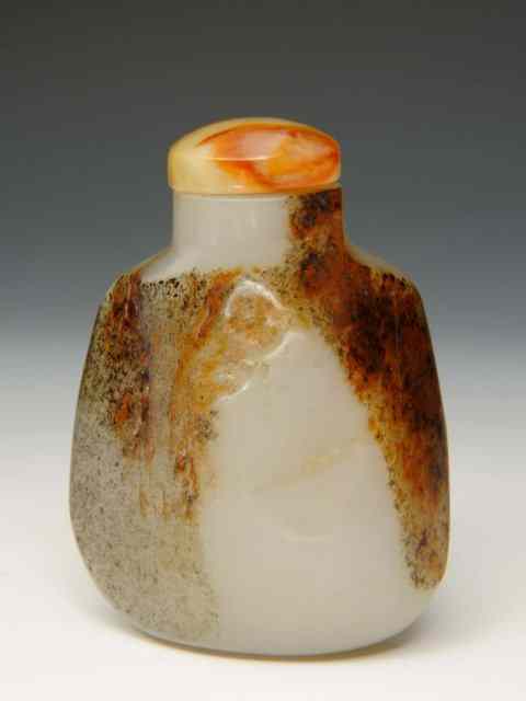 Appraisal: A CHINESE DUST BROWN AND MUTTON FAT JADE IRREGULAR SHAPED