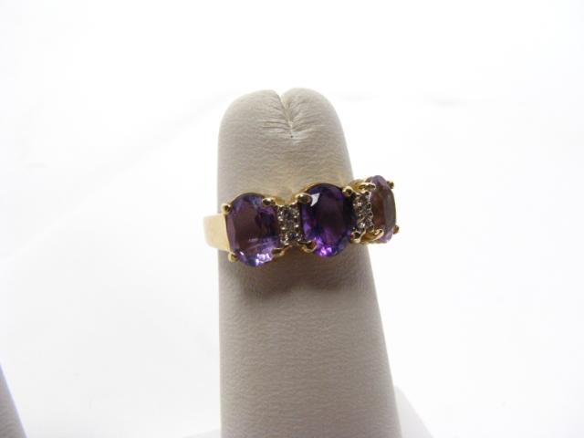 Appraisal: K yellow gold lady's ring set with three rectangular amethyst