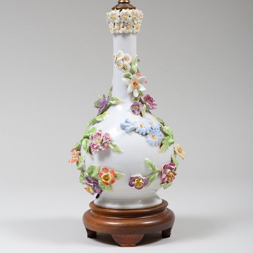 Appraisal: CONTINENTAL PORCELAIN FLOWER ENCRUSTED BOTTLE VASE MOUNTED AS A LAMP