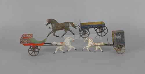 Appraisal: Three tin lithograph horse drawn wagons ca longest - l