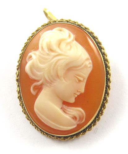 Appraisal: PORTRAIT CAMEO PENDANT BROOCH k yellow gold frames the relief-carved