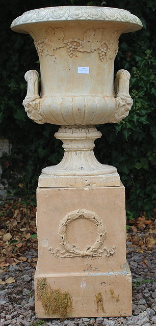 Appraisal: A STONEWARE GARDEN URN with gadrooned rim satire mask handles