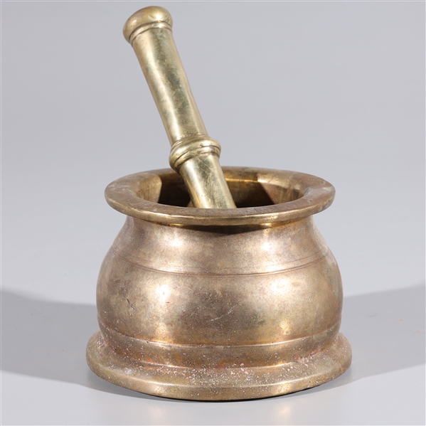 Appraisal: Antique Indian gilt bronze mortar and pestle with incised designs