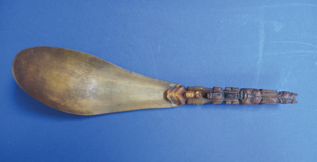 Appraisal: A CARVED AND SHAPED BONE SPOON possibly Hyda the handle