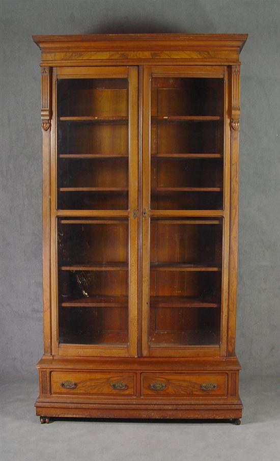 Appraisal: Walnut Victorian Bookcase Circa Two piece construction Bold cavetto molded