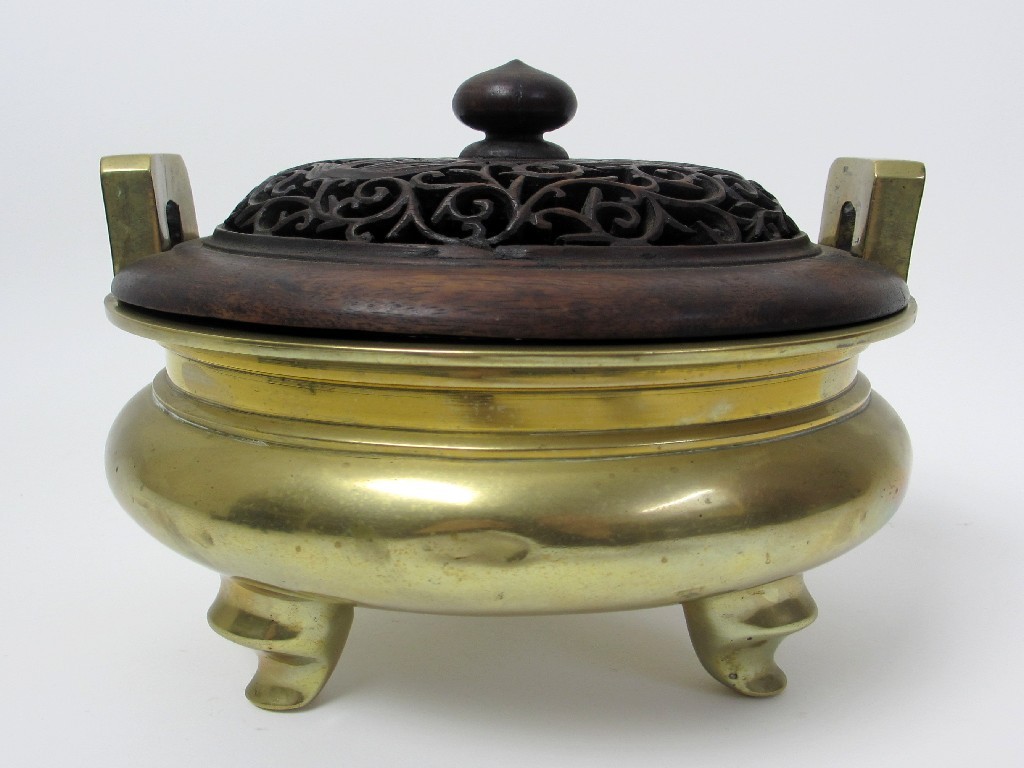 Appraisal: A Chinese bronze censer with vertical pierced handles four character