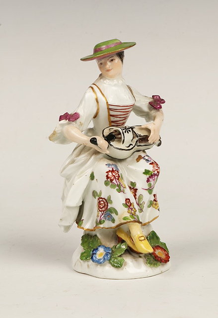 Appraisal: AN TH CENTURY MEISSEN FIGURE OF COLUMBINE PLAYING THE HURDY-GURDY