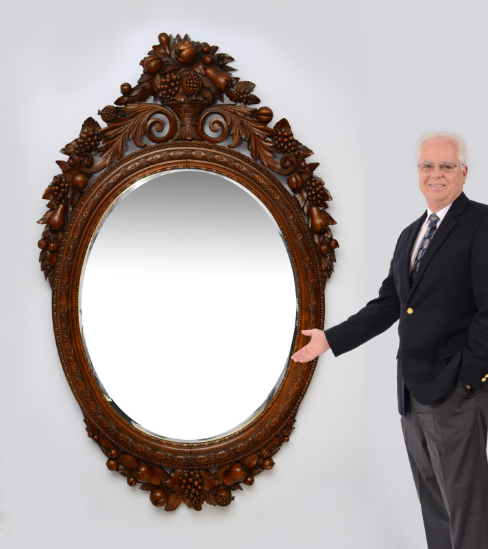 Appraisal: PALATIAL OVAL CARVED FRUIT MIRROR Profusely carved frame with fruit