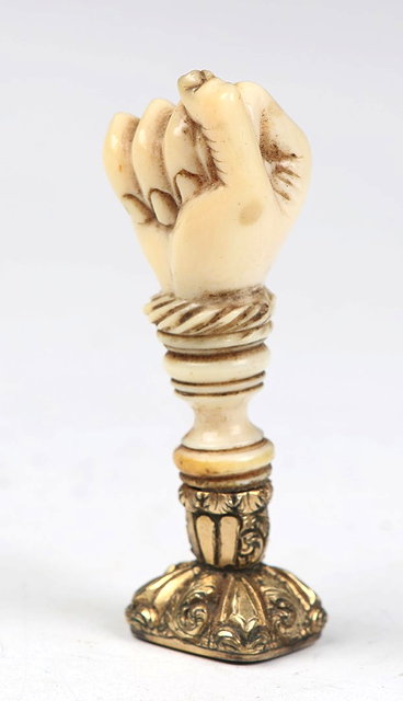 Appraisal: A GILT METAL AND CARVED IVORY SEAL in the form