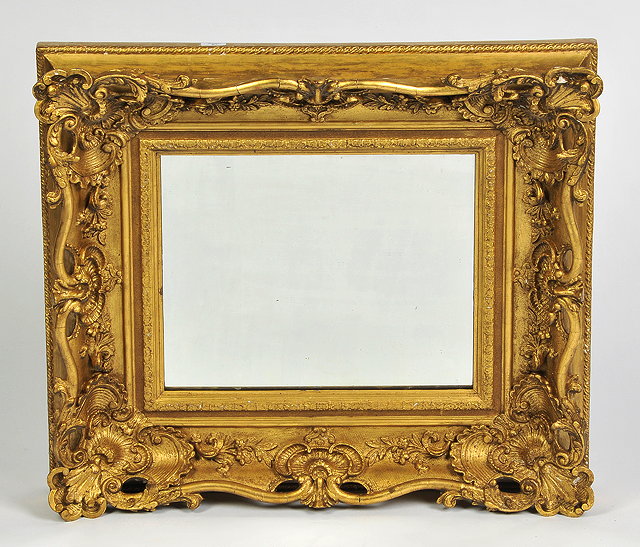 Appraisal: A VICTORIAN GILT PLASTER WALL MIRROR with scroll frame cm