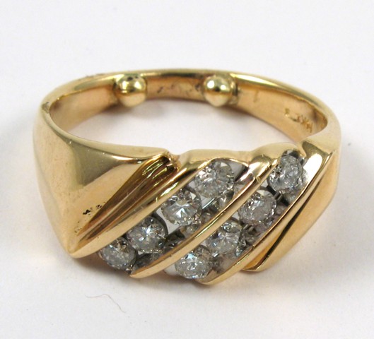 Appraisal: DIAMOND AND FOURTEEN KARAT GOLD RING set with eight channel