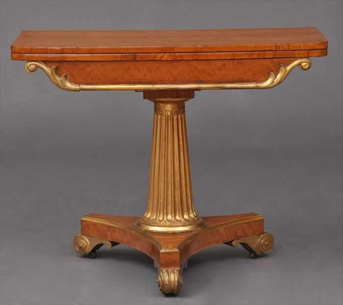 Appraisal: WILLIAM IV CARVED SATINWOOD AND PARCEL-GILT GAMES TABLE The folding