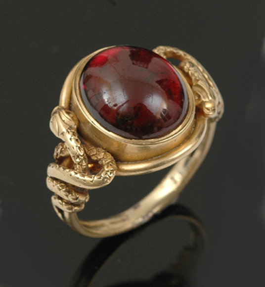 Appraisal: A Victorian garnet set ring Centrally bezel set with an