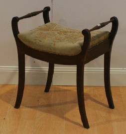 Appraisal: A th century stained pine and upholstered piano stool