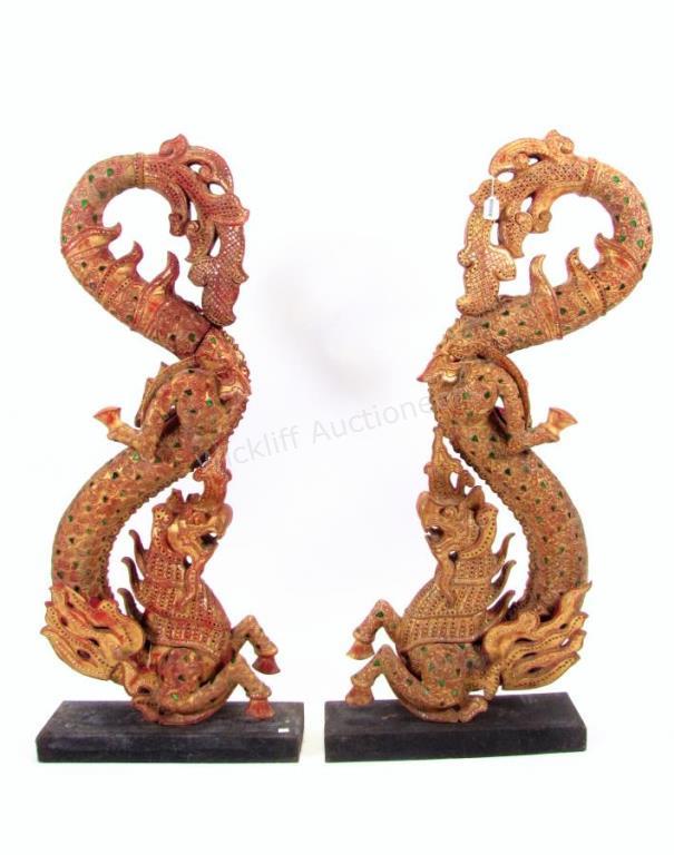 Appraisal: A pair of Balinese carvings depicting dragons painted finish with