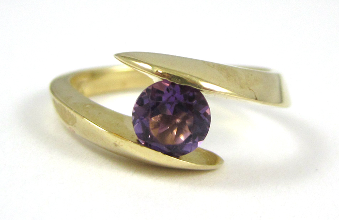 Appraisal: AMETHYST AND FOURTEEN KARAT GOLD RING set with a single