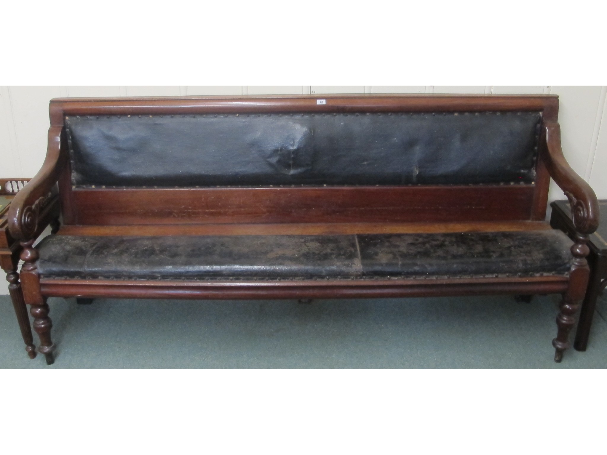 Appraisal: A Victorian mahogany hall bench with leather padded seat and