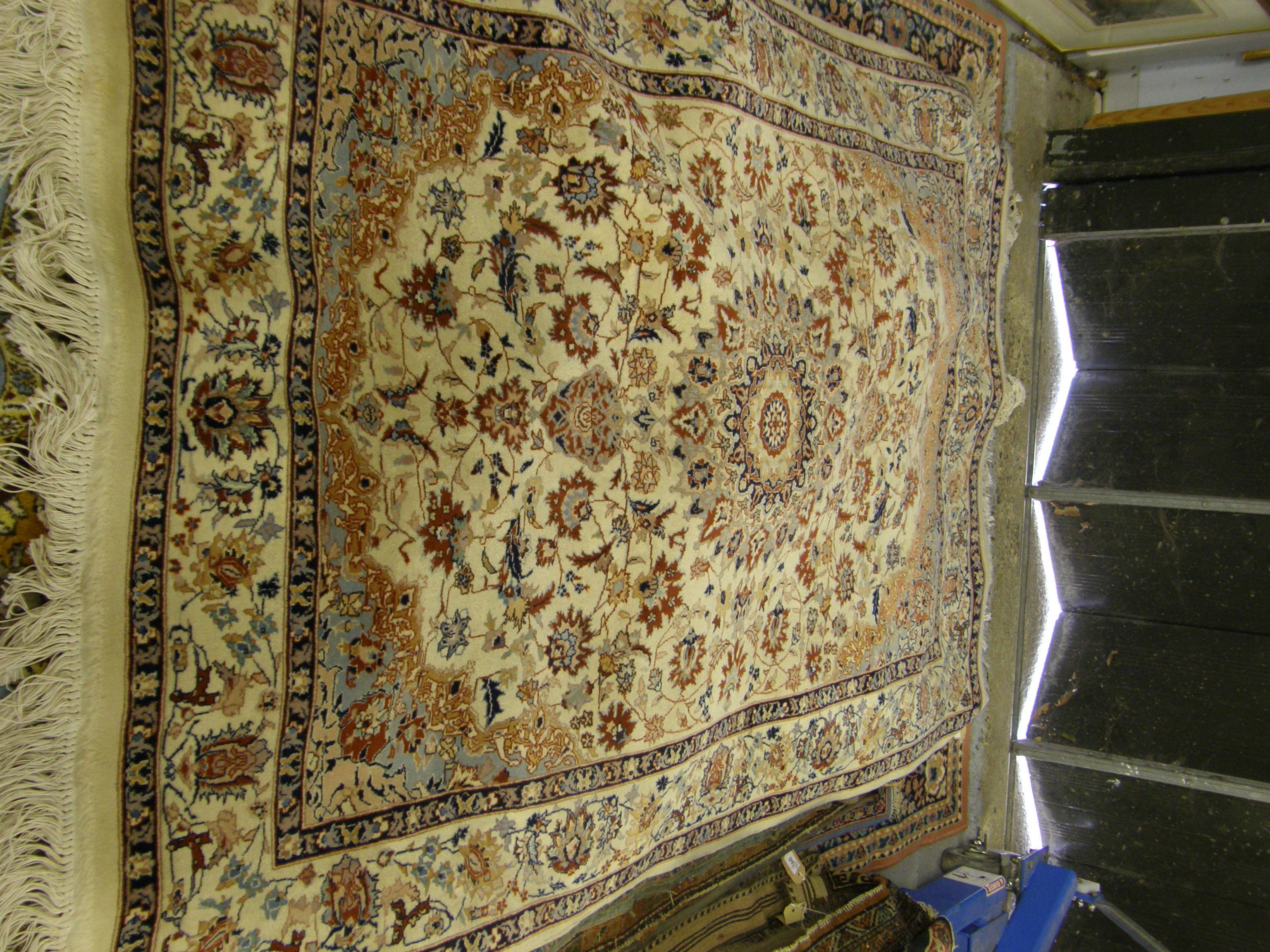 Appraisal: Modern cream ground rug the centre with a flower shaped