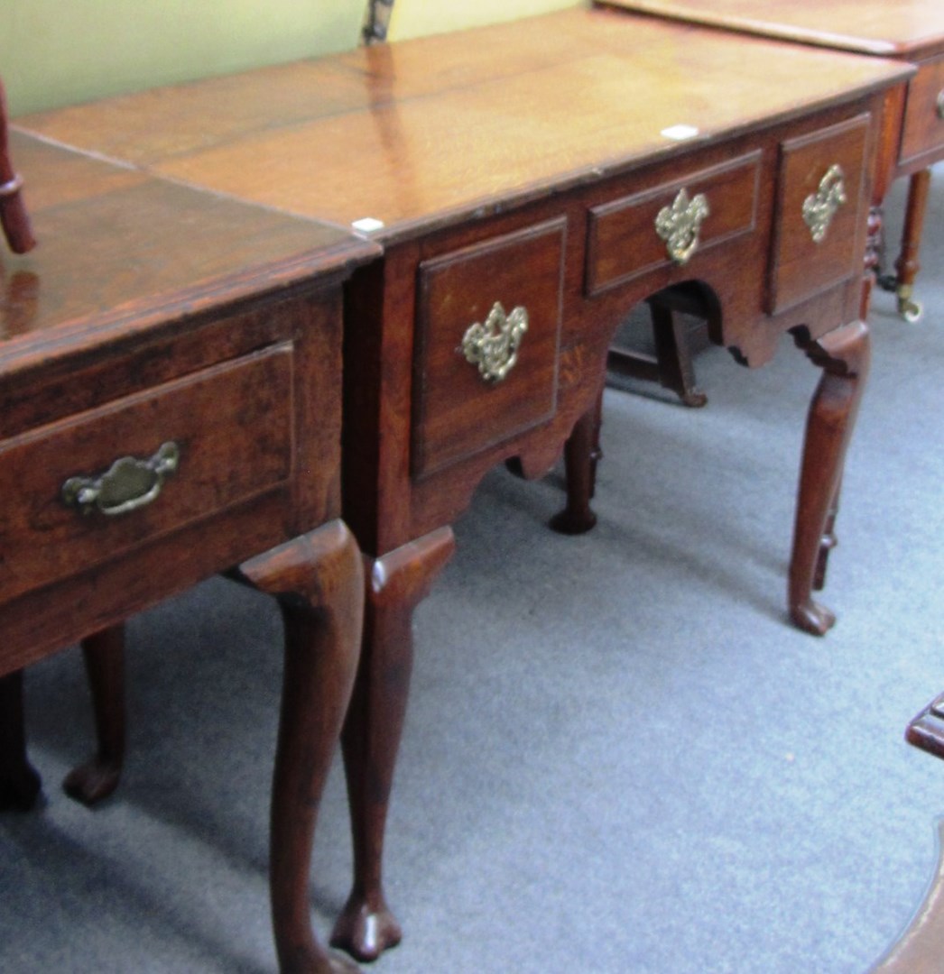 Appraisal: A mid th century oak lowboy the plank top over