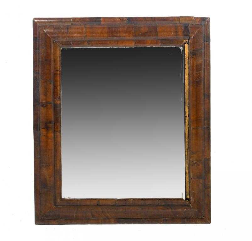 Appraisal: A WILLIAM III WALNUT CUSHION MOULDED MIRROR with replaced bevelled