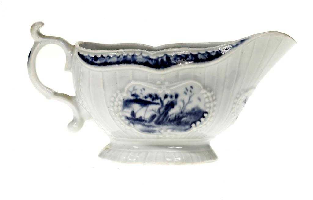 Appraisal: A WORCESTER STRAP FLUTED SAUCE BOAT the moulded cartouches painted