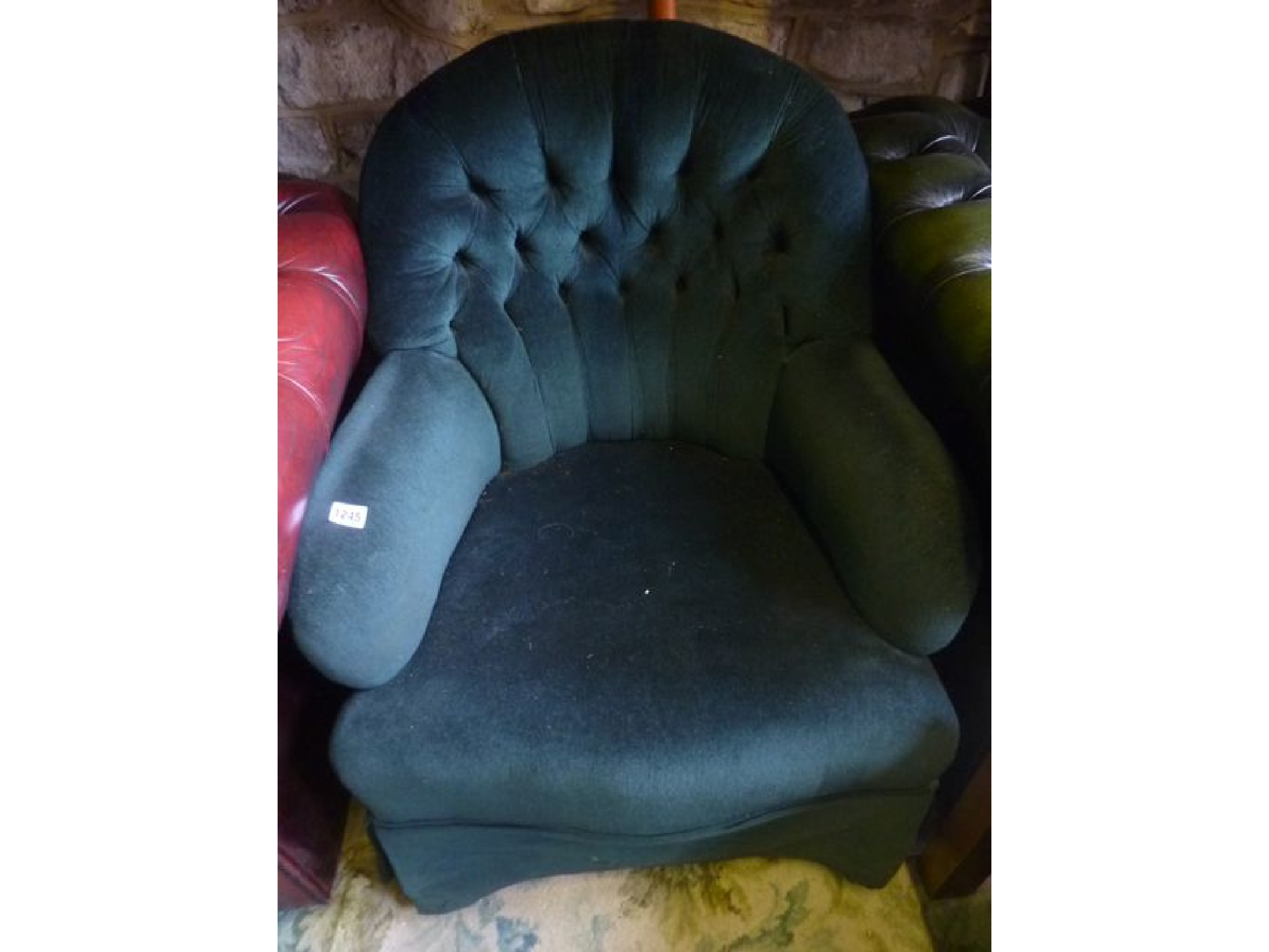 Appraisal: A Victorian style low button back chair with shaped outline