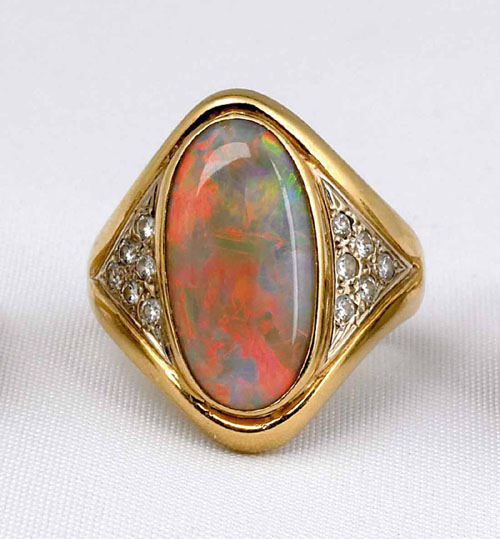 Appraisal: K yellow gold opal and diamond ring with center oval