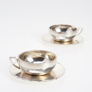 Appraisal: Pair Jean Puiforcat silver cups and saucers Pair Jean Puiforcat