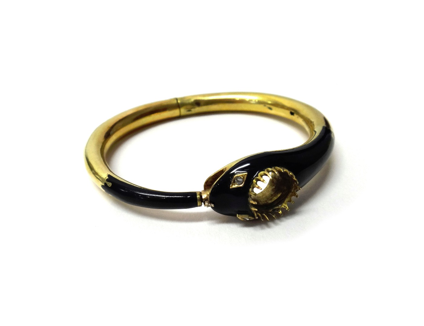 Appraisal: A gold and black enamelled hinged bangle designed as a