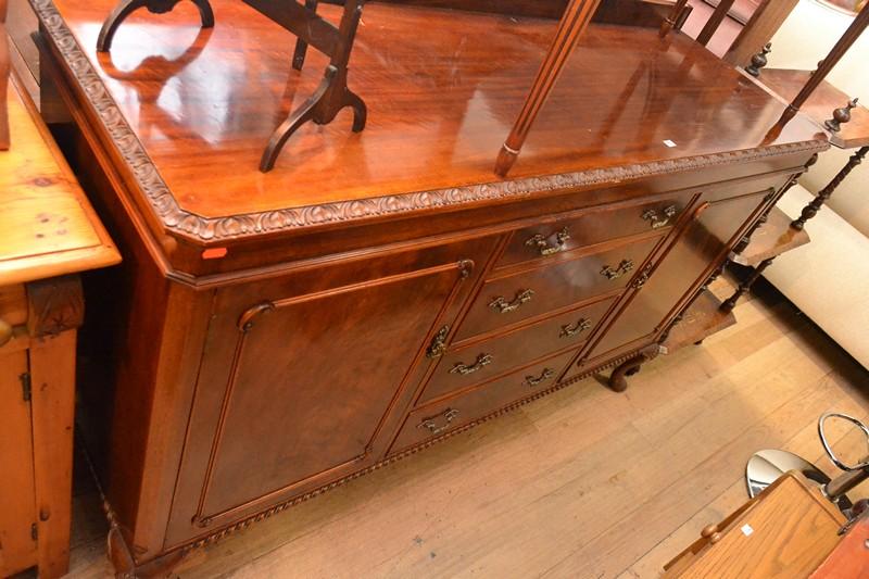 Appraisal: A CHIPPENDALE STYLE TWO DOOR SIDEBOARD WITH FOUR CENTRAL DRAWERS