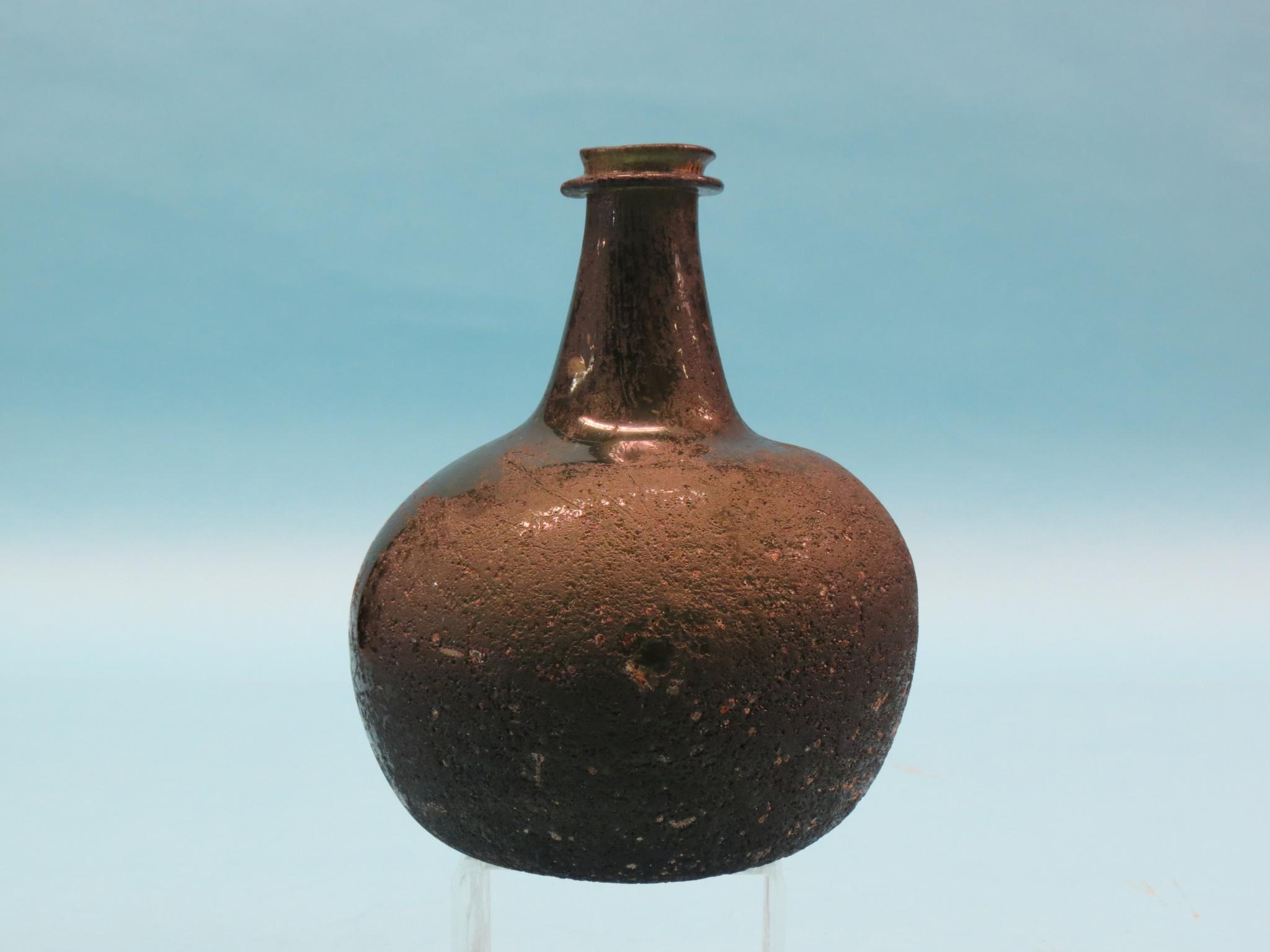 Appraisal: An early th century glass wine bottle deep-green with iridescence